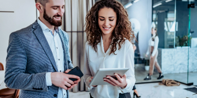 Business Man and Woman Looking at Tablet