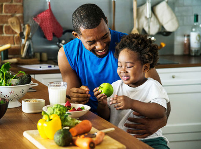 Man Feeding Child Apple